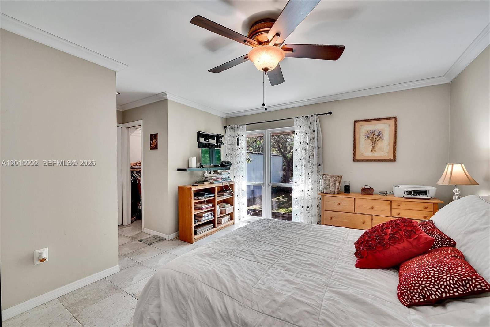 3300 Atlanta Street, Unit 15F Hollywood, FL 33021 - Photo 21 of 30 a bedroom with a bed dresser and a chandelier
