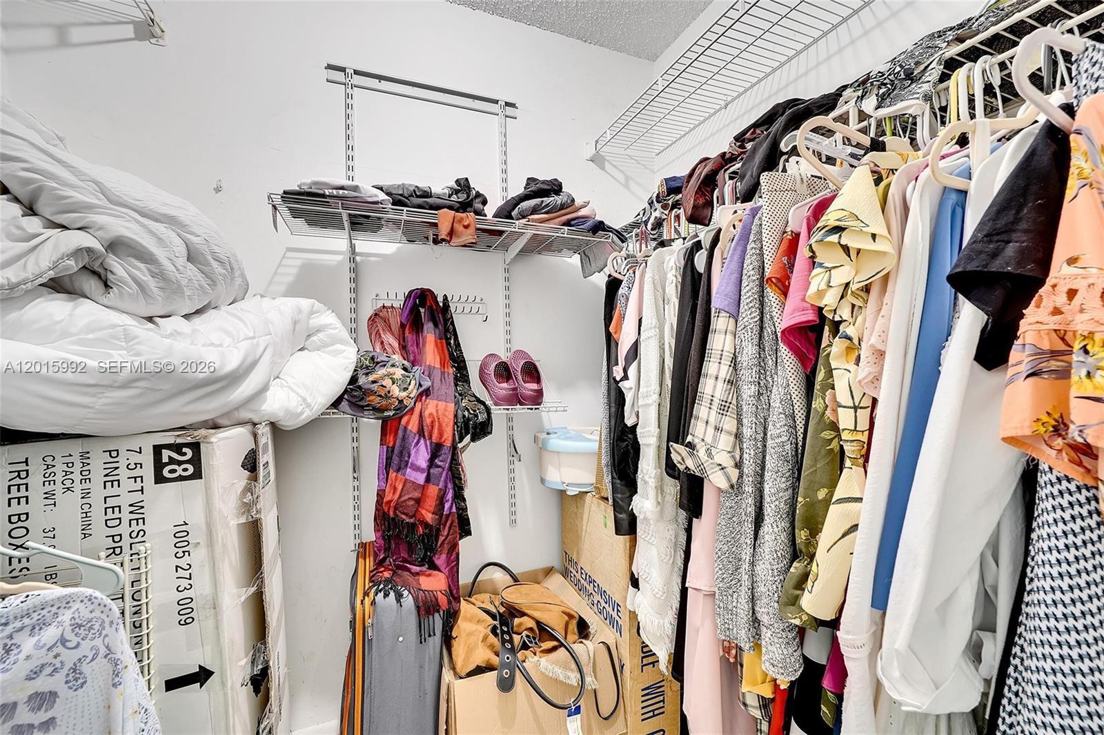 3300 Atlanta Street, Unit 15F Hollywood, FL 33021 - Photo 24 of 30 a view of walk in closet with clothes