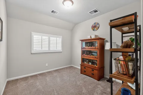 an empty room with windows and closet