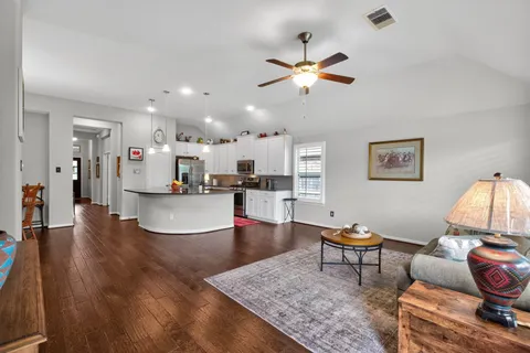 a living room with furniture and kitchen view