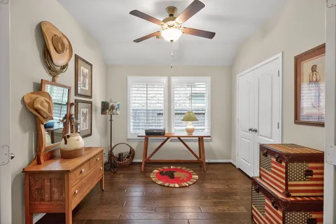 a living room with furniture a window and gym equipment