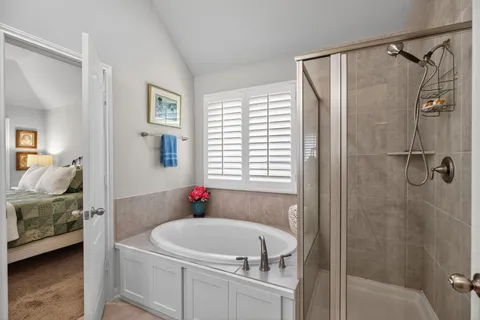 a en suite bathroom with a tub and a shower