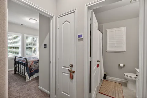 a bathroom with a granite countertop sink a toilet and shower