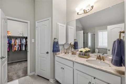 a bathroom with double sink and a mirror