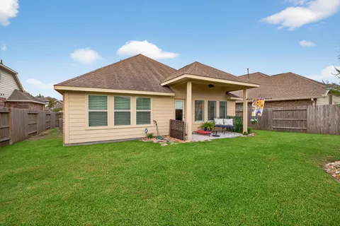 a view of a house with a backyard