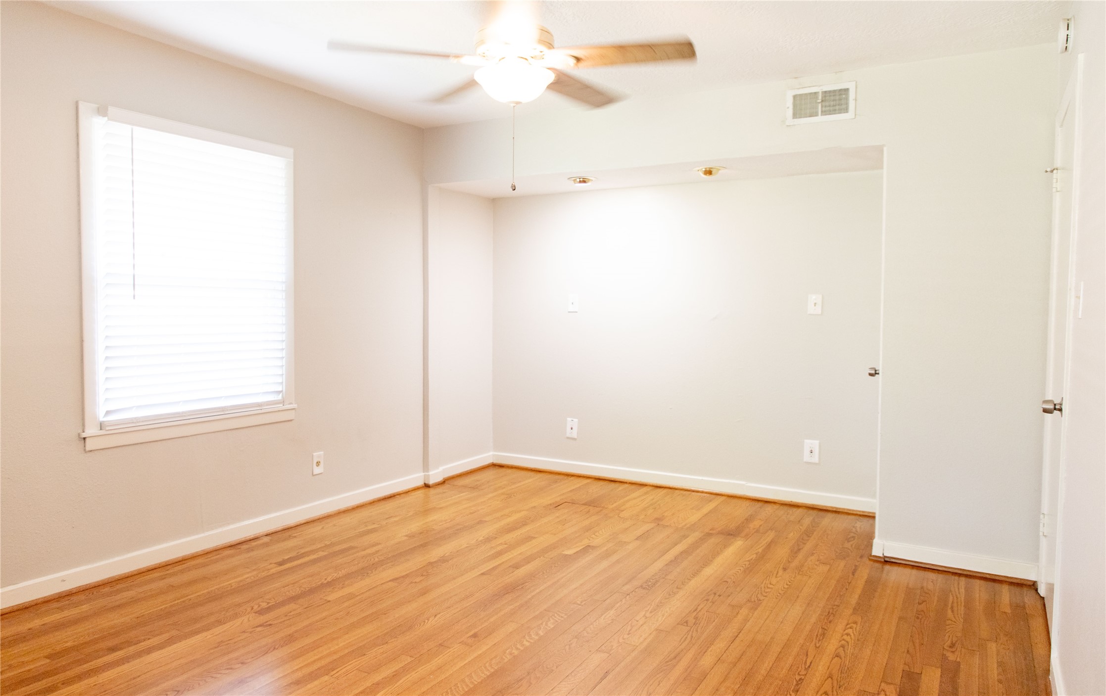 3314 Rochdale Street Houston, TX 77025 - Photo 17 of 29 an empty room with a window and wooden floor