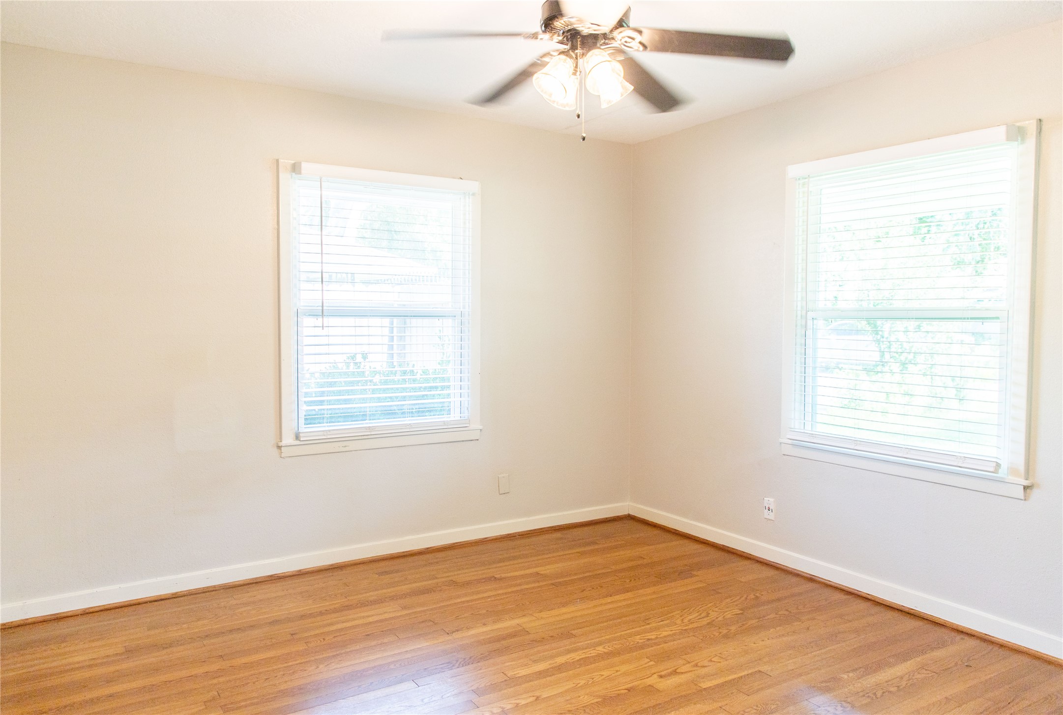 3314 Rochdale Street Houston, TX 77025 - Photo 22 of 29 an empty room with wooden floor fan and windows