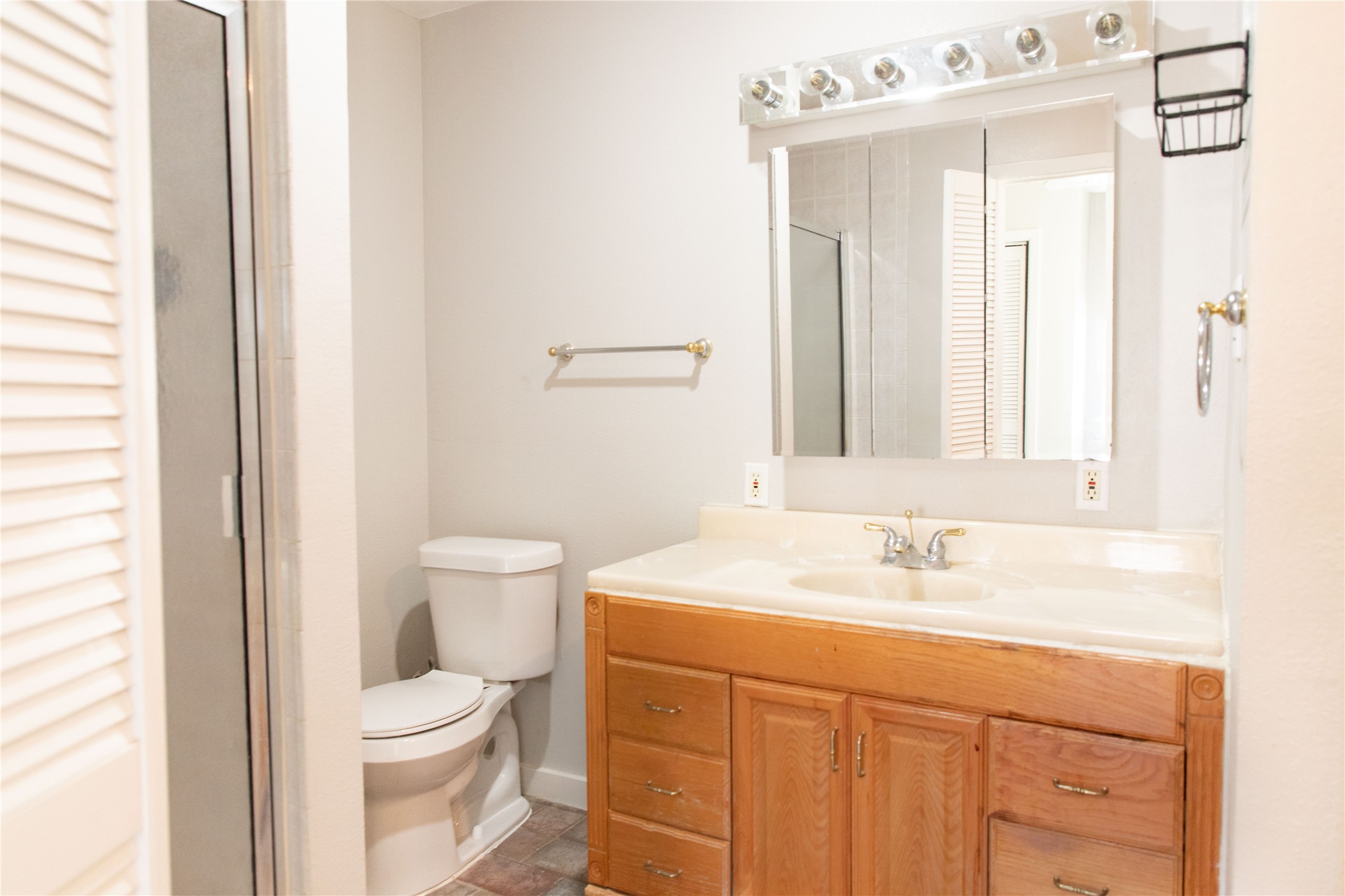 3314 Rochdale Street Houston, TX 77025 - Photo 26 of 29 a bathroom with a sink a toilet and a mirror