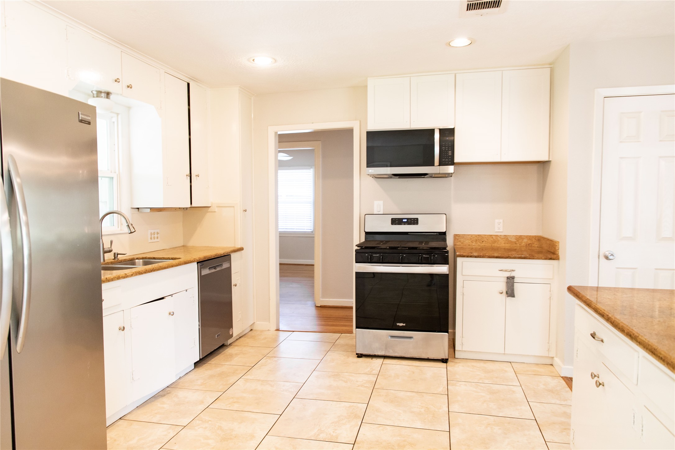 3314 Rochdale Street Houston, TX 77025 - Photo 6 of 29 a kitchen with stainless steel appliances a refrigerator sink and microwave