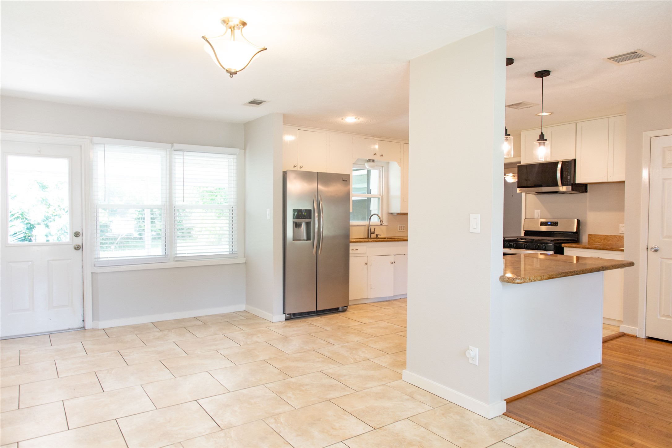 3314 Rochdale Street Houston, TX 77025 - Photo 7 of 29 a kitchen with stainless steel appliances kitchen island granite countertop a refrigerator and a sink
