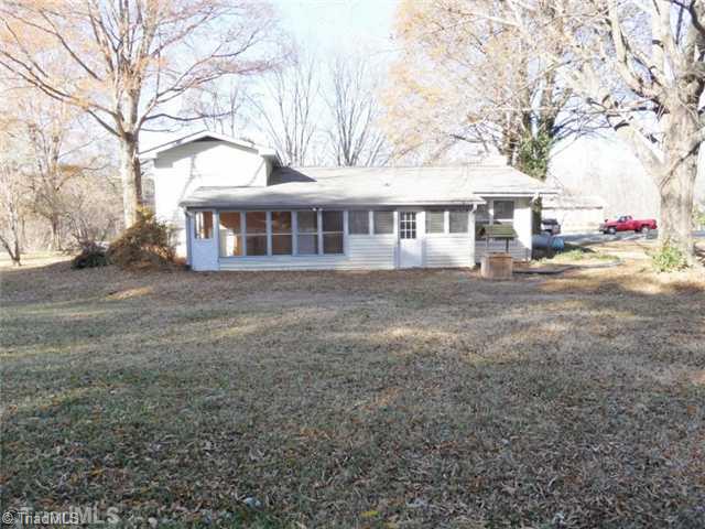 6804 Ivy Lane Oak Ridge, NC 27310 - Photo 16 of 16 Exterior Back. The back offers a large, level backyard!