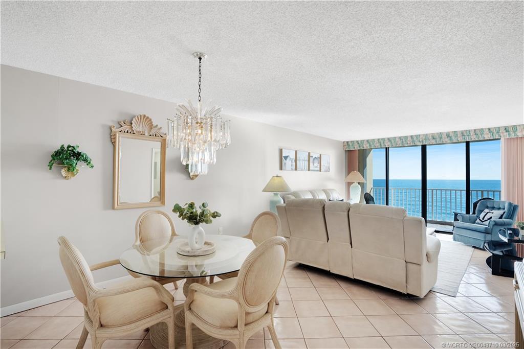 3200 North Hwy A1A, Unit 805 Fort Pierce, FL 34949 - Photo 16 of 43 a living room with furniture and a chandelier