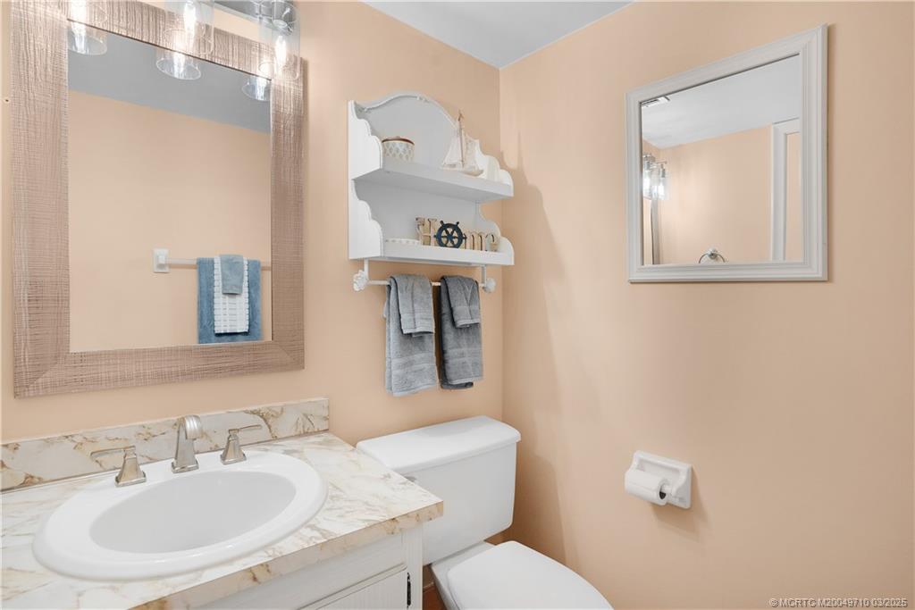 3200 North Hwy A1A, Unit 805 Fort Pierce, FL 34949 - Photo 17 of 43 a bathroom with a sink mirror and toilet