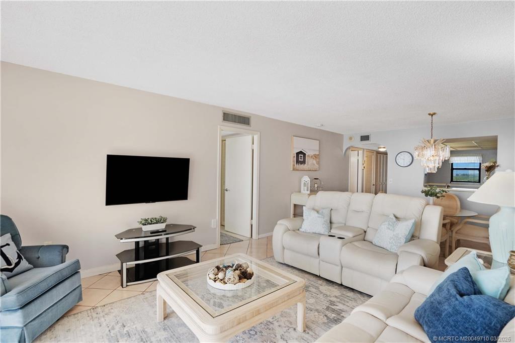 3200 North Hwy A1A, Unit 805 Fort Pierce, FL 34949 - Photo 20 of 43 a living room with furniture a rug and a flat screen tv