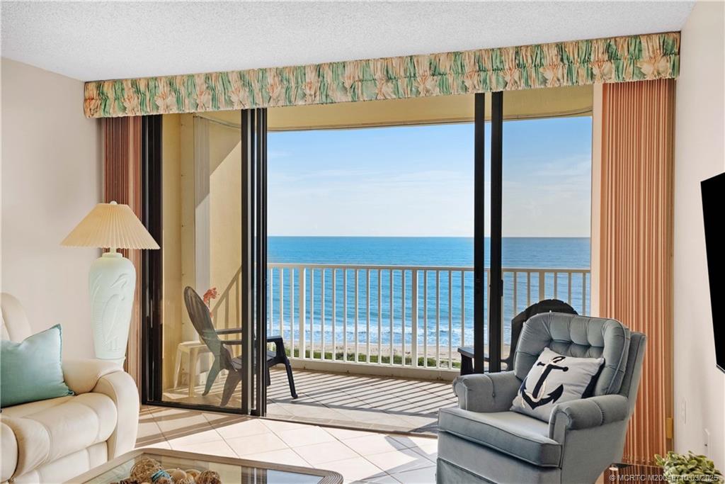3200 North Hwy A1A, Unit 805 Fort Pierce, FL 34949 - Photo 2 of 43 a living room with furniture and a floor to ceiling window