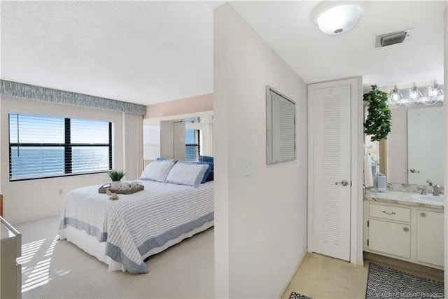 a bedroom with a bed and flat screen tv