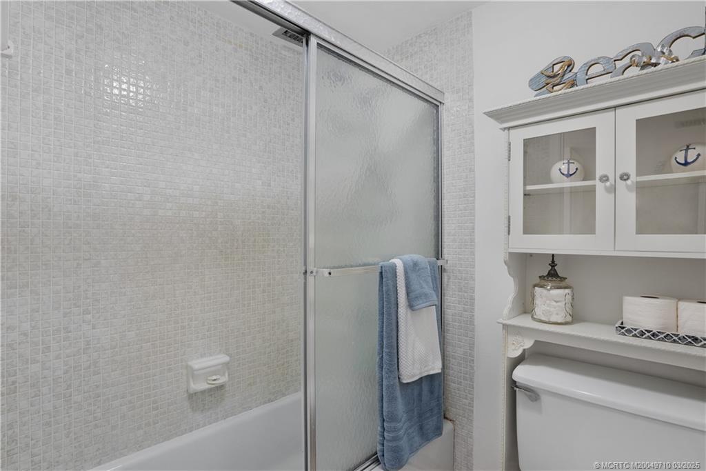 3200 North Hwy A1A, Unit 805 Fort Pierce, FL 34949 - Photo 25 of 43 a bathroom with a granite countertop sink a toilet and shower