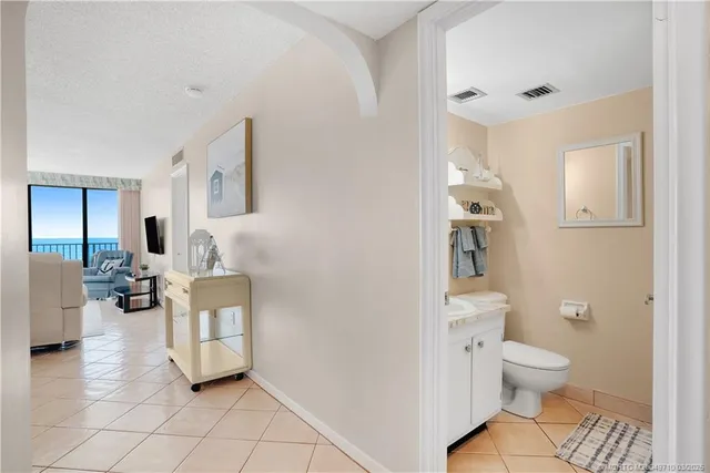 a kitchen with stainless steel appliances white cabinets and a refrigerator