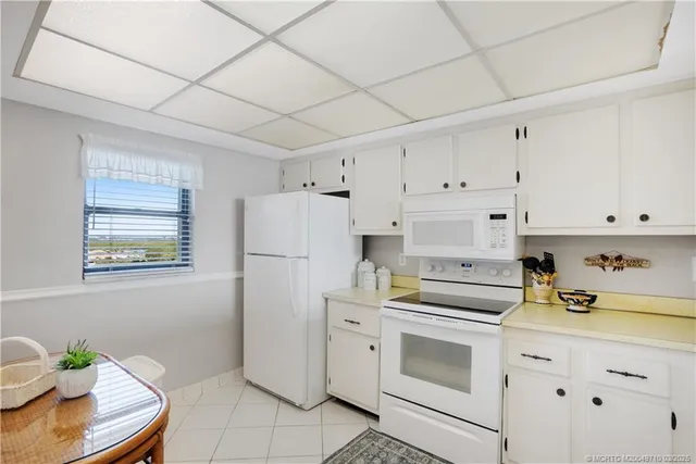 a kitchen with cabinets appliances a sink and a counter space
