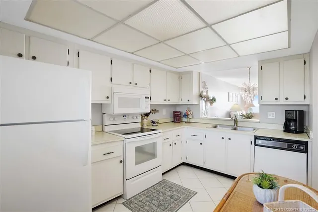 a kitchen with cabinets appliances a sink and a counter space