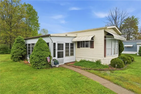 a view of a house with a yard and plants