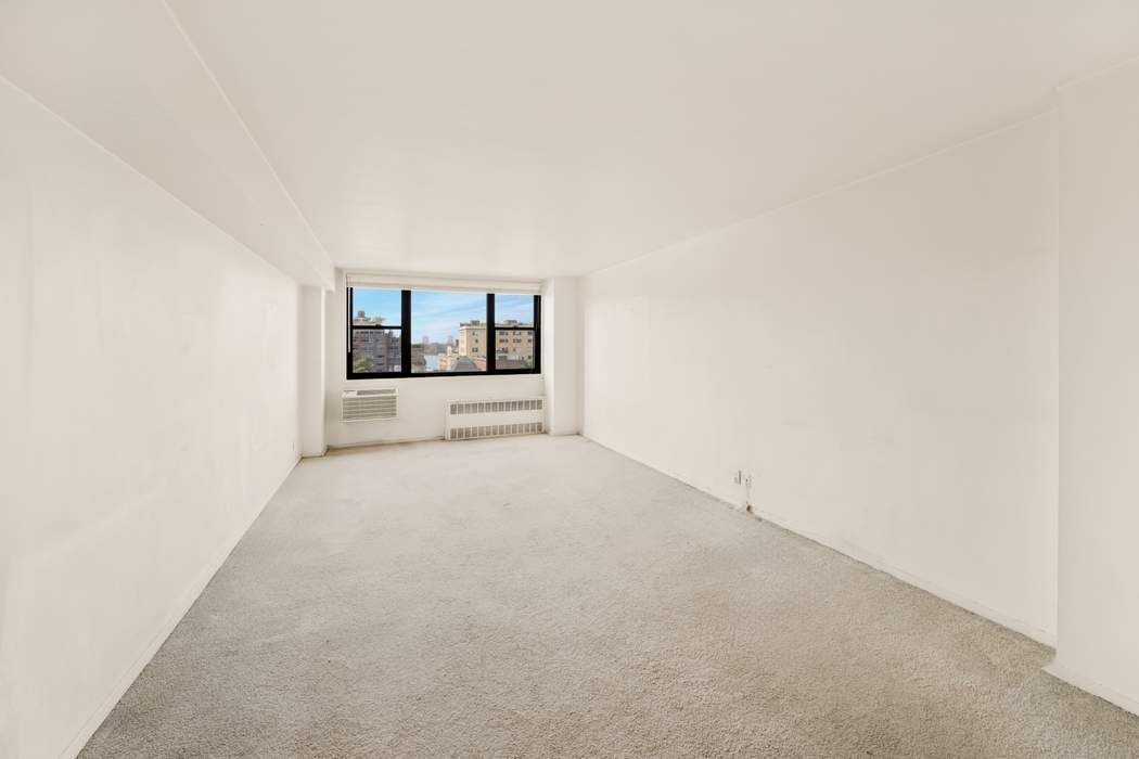 61 Jane Street, Unit 10N Manhattan, NY 10014 - Photo 2 of 13 a view of a big room with closet and windows