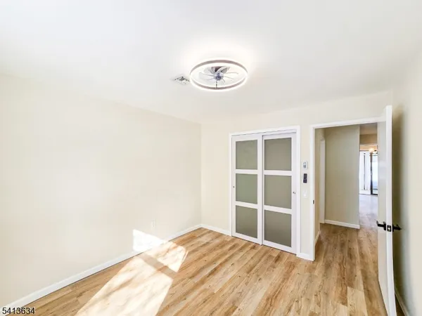 a view of a room with wooden floor and bathroom
