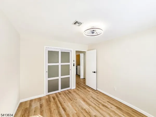 a view of a room with wooden floor and window