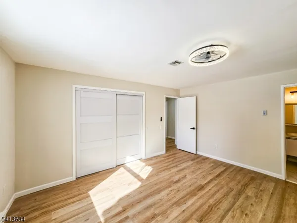 a view of a room with a bed and a window