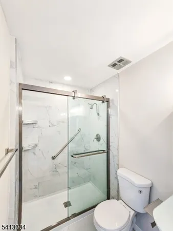 a bathroom with a toilet and a shower