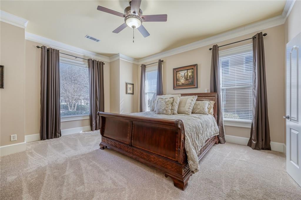 2380 Muskogee Lane Braselton, GA 30517 - Photo 19 of 30 a spacious bedroom with a bed and a chandelier
