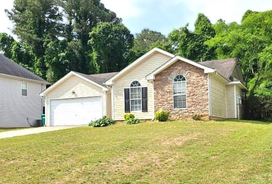 1443 Pebble Ridge Lane Hampton, GA 30228 - Photo 3 of 24 a front view of a house with yard and garage