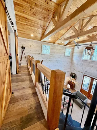 a view of wooden stairs and windows in a room