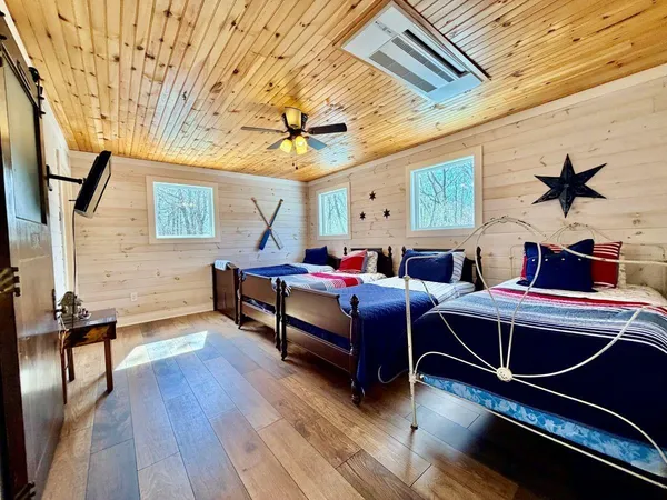 a bedroom with furniture and wooden floor