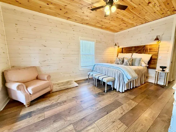 a spacious bedroom with a bed and a couch