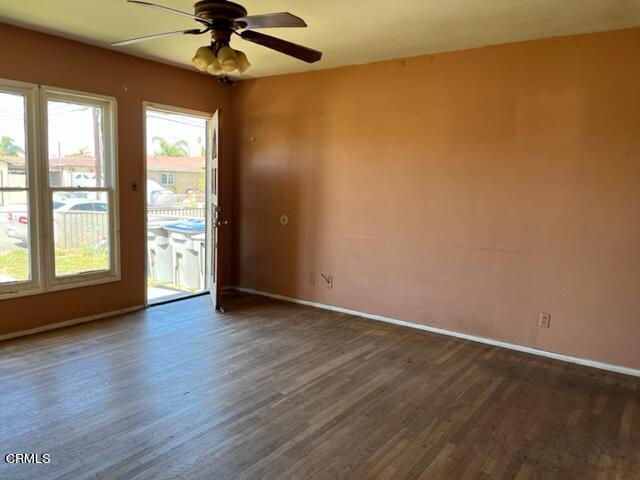 5084 Bradfield Place Oxnard, CA 93033 - Photo 6 of 12 an empty room with wooden floor fan and windows