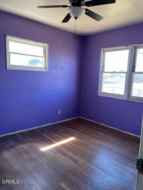 5084 Bradfield Place Oxnard, CA 93033 - Photo 7 of 12 an empty room with wooden floor and windows