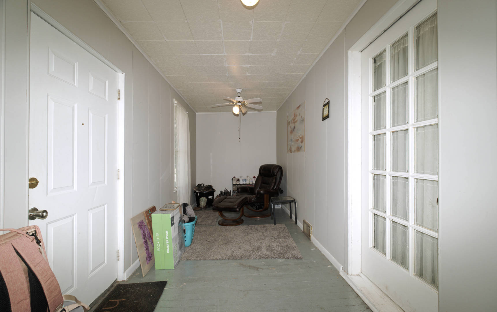 2108 Camanche Avenue Clinton, IA 52732 - Photo 15 of 22 a hallway with a couch and a dining table next to a window
