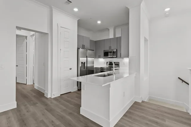 a kitchen with white cabinets and white appliances