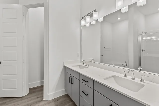 a bathroom with double sink and a mirror