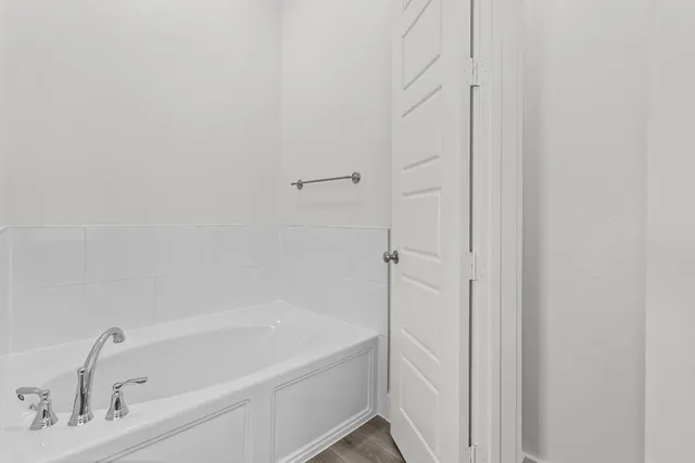 a white bath tub sitting next to a white sink