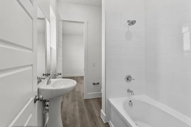 a bathroom with a sink a mirror and a bathtub