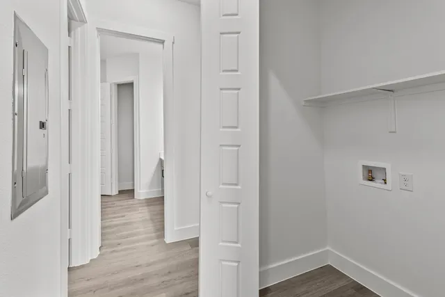 a view of a hallway with wooden floor