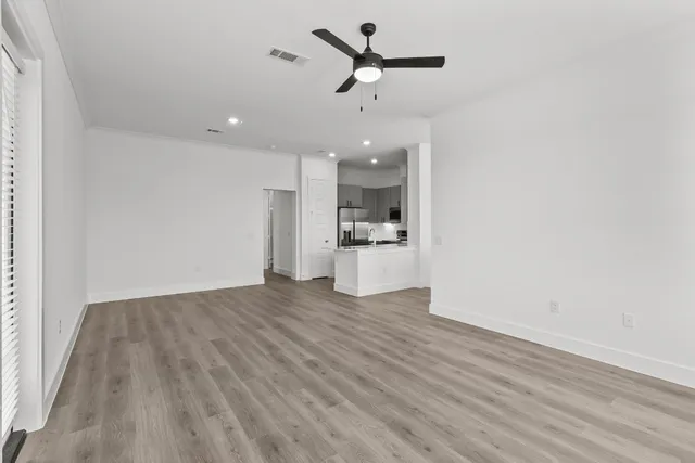 a view of a kitchen with a sink and a refrigerator