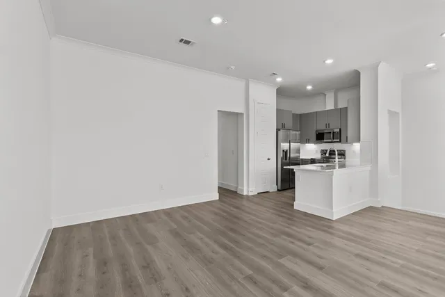 a view of kitchen with granite countertop cabinets and refrigerator