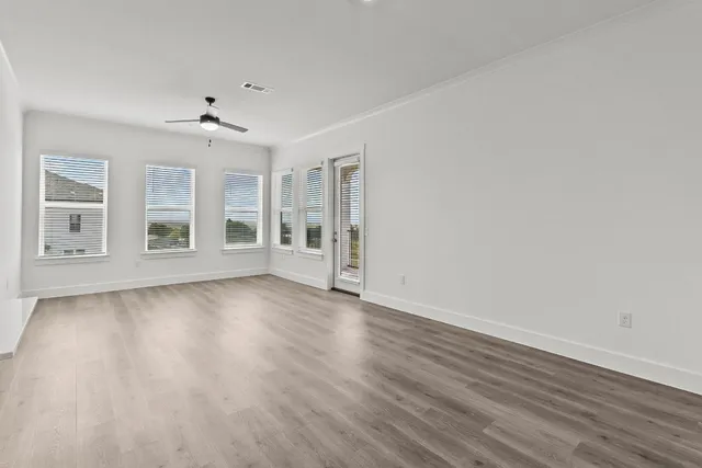 wooden floor in an empty room with a window