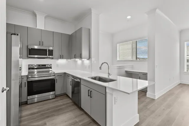 a kitchen with stainless steel appliances granite countertop a sink stove and refrigerator