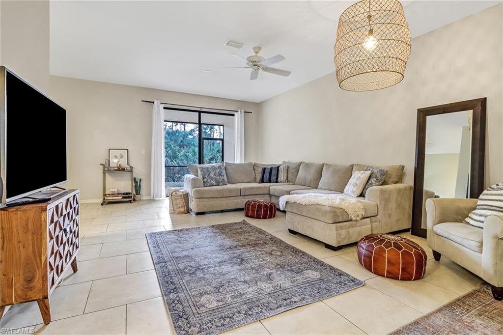 15190 Summit Pl Circle, Unit 196 Naples, FL 34119 - Photo 1 of 35 a living room with furniture and a flat screen tv