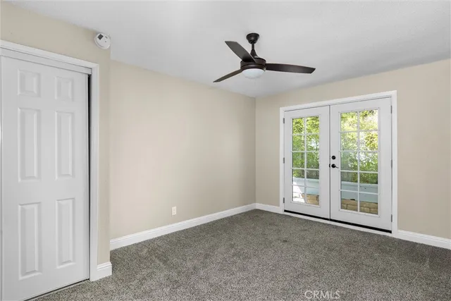 a view of a livingroom with a ceiling fan and window