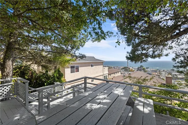 a view of a roof deck with wooden floor and fence